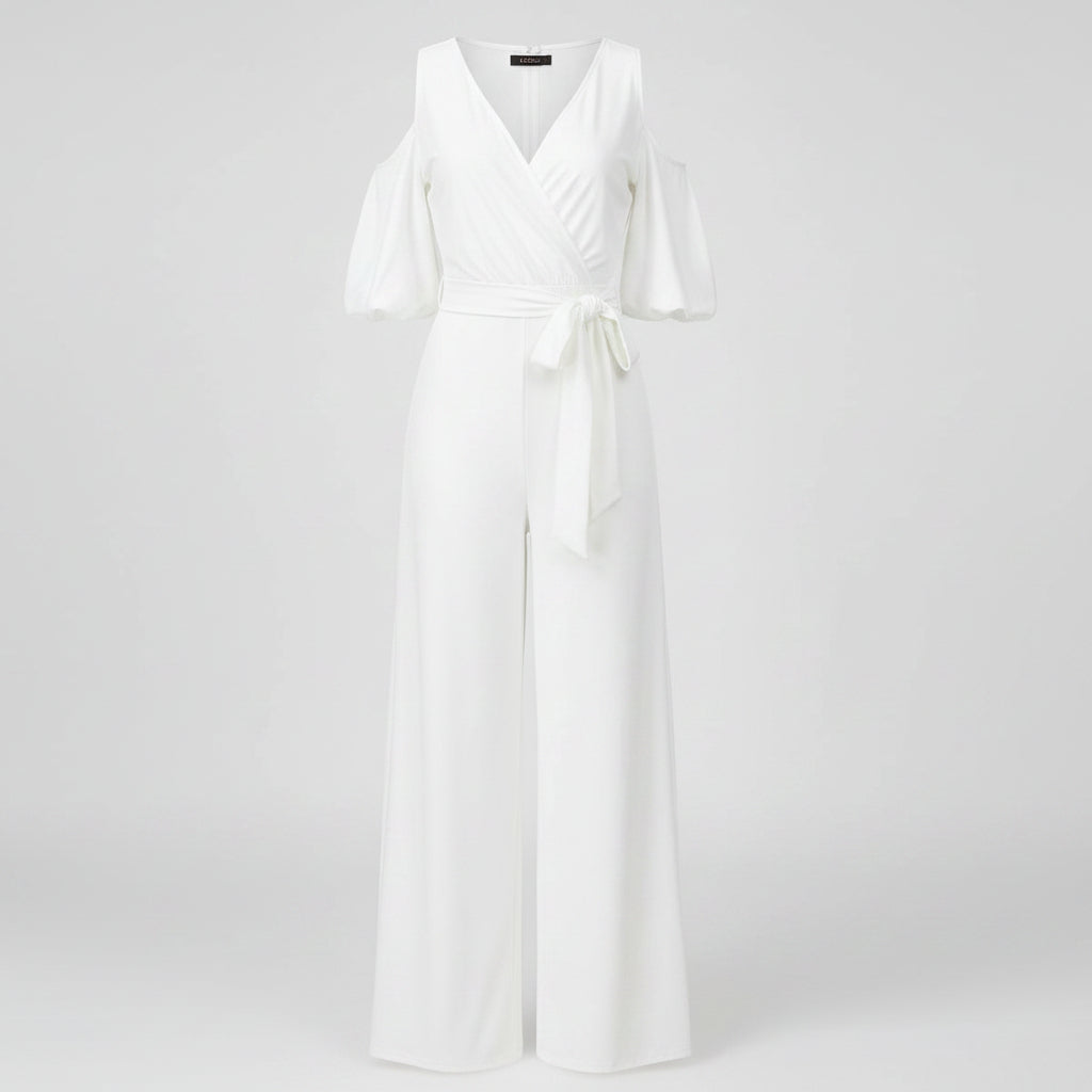 Woman wearing a white jumpsuit with cold shoulder design on a white background