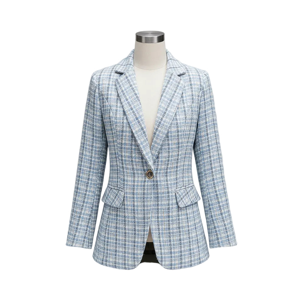 Woman wearing a light blue checkered blazer in an indoor setting