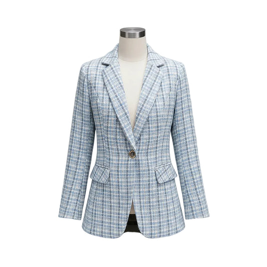 Woman wearing a light blue checkered blazer in an indoor setting