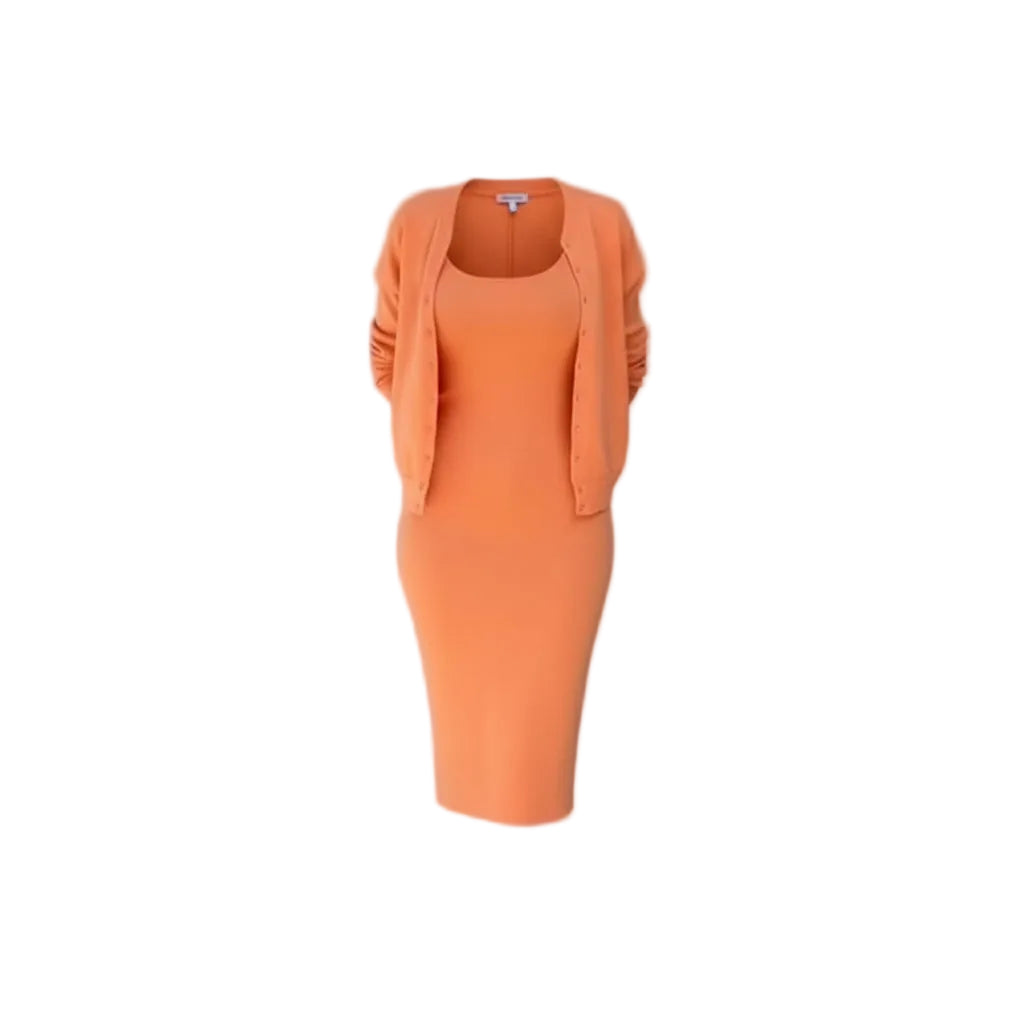 Person wearing an orange outfit standing against a light gray wall.