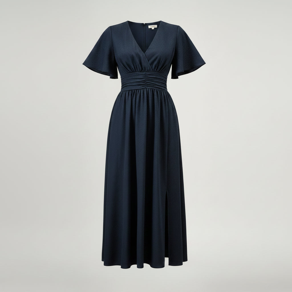 Woman wearing a navy blue dress with a cactus plant in the background