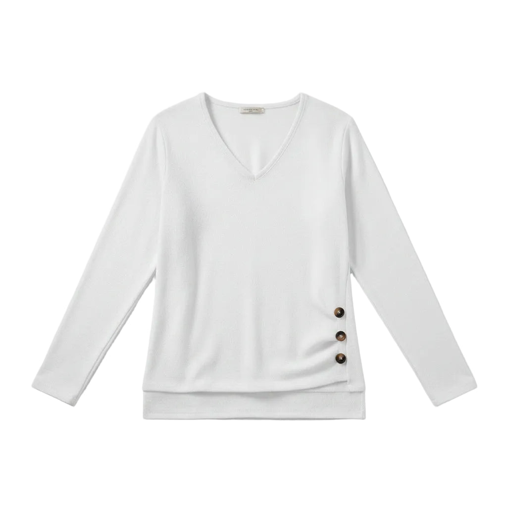 A woman wearing a white long-sleeve V-neck sweater with three dark brown buttons on the side, paired with blue jeans.